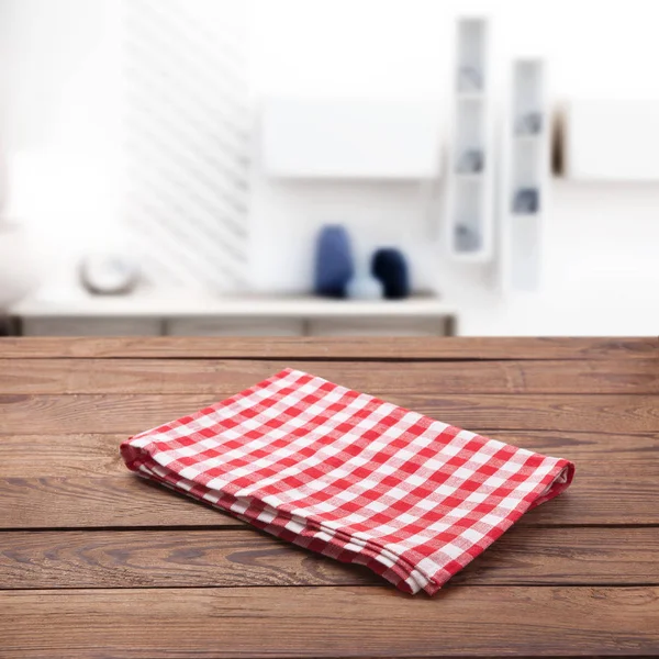 Kitchen towel on empty wooden table. Napkin close up top view mock up for design. Kitchen rustic background.