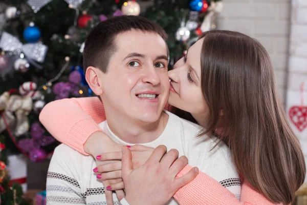 Young couple hugging in Christmas time at home — Stock Photo, Image