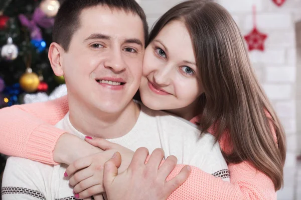 Young couple hugging in Christmas time at home — Stock Photo, Image