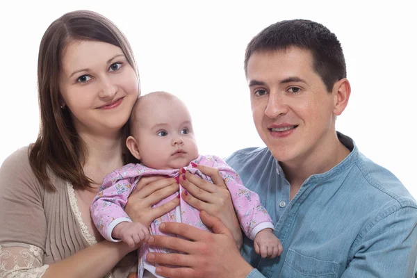 Portrait of happy young parents with baby in the bed at home — Stock Photo, Image