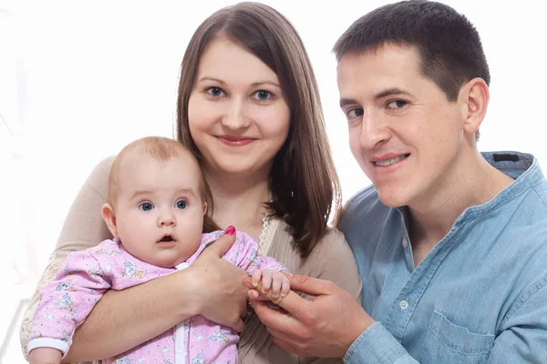 Family, parenthood and people concept - happy mother, father with baby daughter at home — Stock Photo, Image