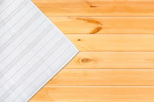 Mantel blanco sobre mesa de madera. maqueta vista superior . — Foto de Stock