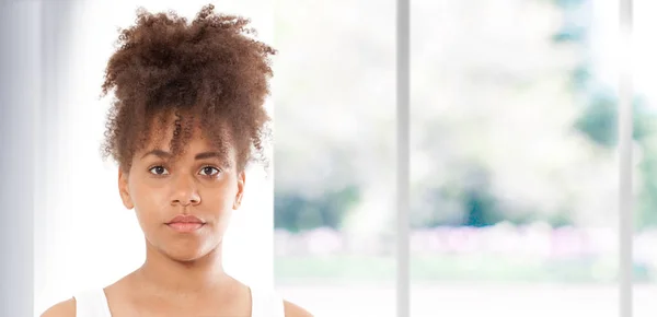 Retrato de una hermosa mujer negra. Atractiva morena de piel oscura mujer en una camiseta blanca . — Foto de Stock