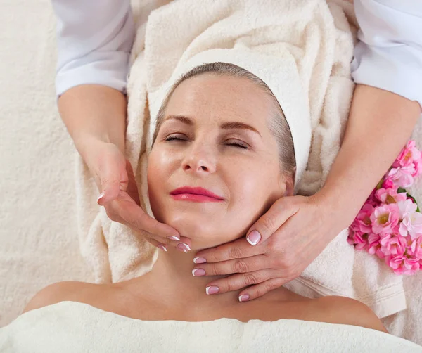 Masaje facial en macro spa. Mujer atractiva con ojos cerrados que cuida la piel. Masaje cara enfoque selectivo . —  Fotos de Stock