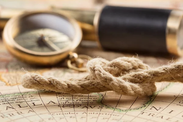 Antique compass, magnifier, spyglass on map — Stock Photo, Image