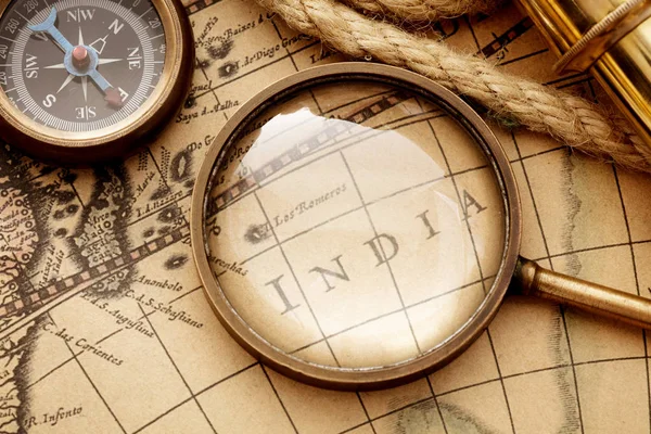 Antique compass, magnifier spyglass on map — Stock Photo, Image