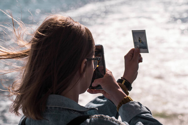 A young girl photographing a photo