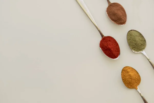 Various colorful spices arranged on spoons — Stock Photo, Image