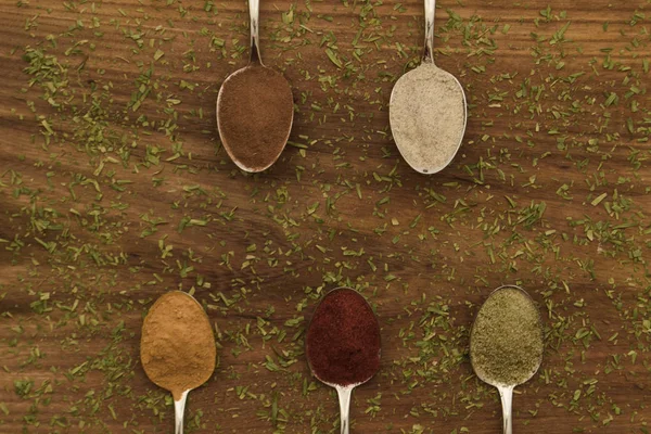 Various colorful spices arranged on spoons — Stock Photo, Image