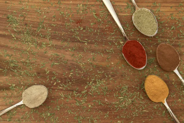 Various colorful spices arranged on spoons — Stock Photo, Image