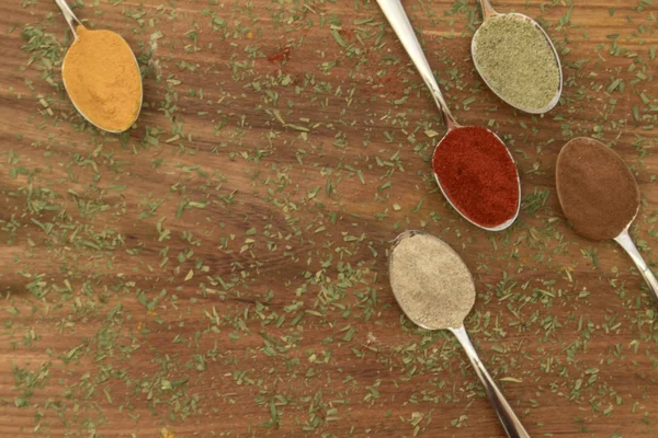 Various colorful spices arranged on spoons — Stock Photo, Image