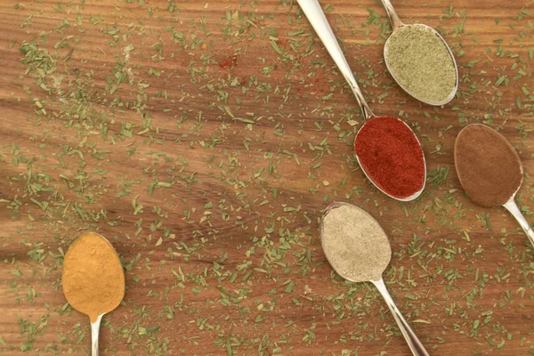 Various colorful spices arranged on spoons — Stock Photo, Image