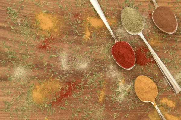 Various colorful spices arranged on spoons — Stock Photo, Image