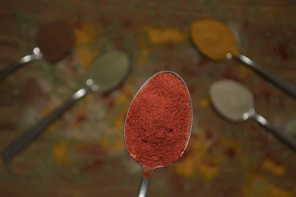 Closeup of red paprika spice on a spoon