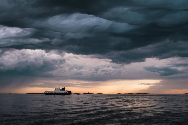 폭풍우가 몰아치는 구름 아래 화물선 스톡 사진
