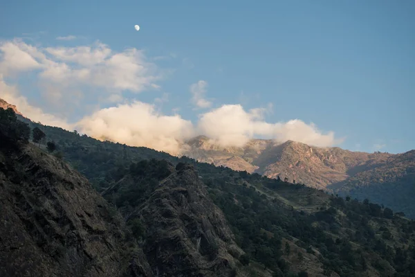 Beautiful scenery with the moon over mountain peaks during the day, Annapurna circuit, Nepal
