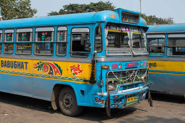 Kolkata, India - February 1, 2020: Two traditional turquoise and yellow public buses parked at a bus station on February 1, 2020 in Kolkata, India