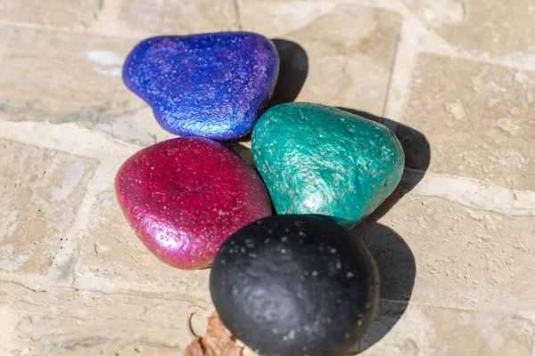 Group of colored stones on ground outside