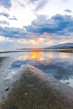 Günbatımında güneş ve renkli bulutlar gizleme ile boş deniz kıyısı