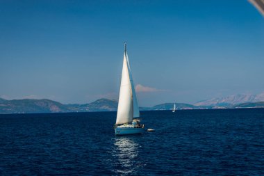 zemin üzerine mavi okyanus su ve dağlar Yelkenli tekne 