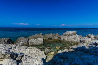 Turkuaz su ve büyük taşlar ile deniz kıyısı