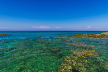Turkuaz su ve büyük taşlar ile deniz kıyısı