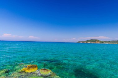 Turkuaz su ve taş ile deniz kıyısı