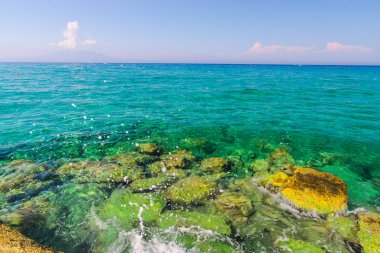 Turkuaz su ve taş ile deniz kıyısı