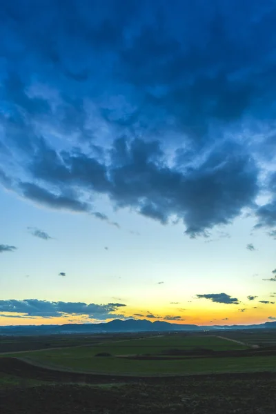 Tavaszi Sunset Mezőben Bujkál Nap Felhők — Stock Fotó