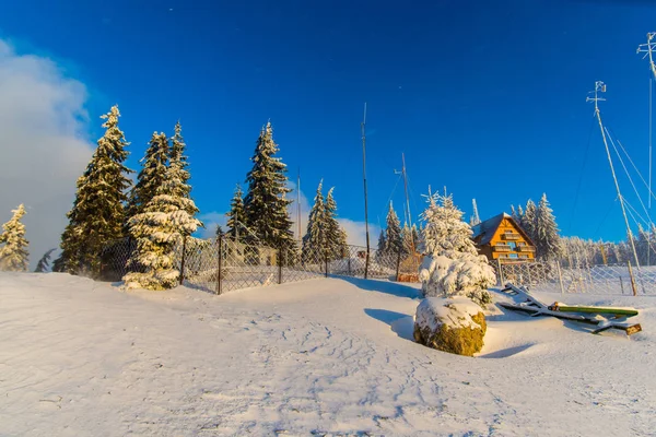 winter snow covered mountains landscape with trees and wooden hut, vacation and ski resort