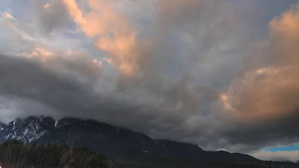 bad weather in mountains, rainy clouds above mountains landscape