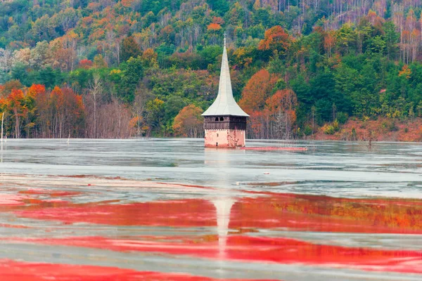 Landscape of flooded church in toxic polluted lake due to copper mining