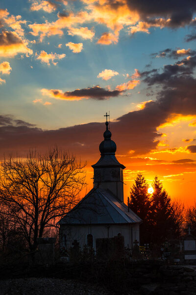 sunset sky and village church 