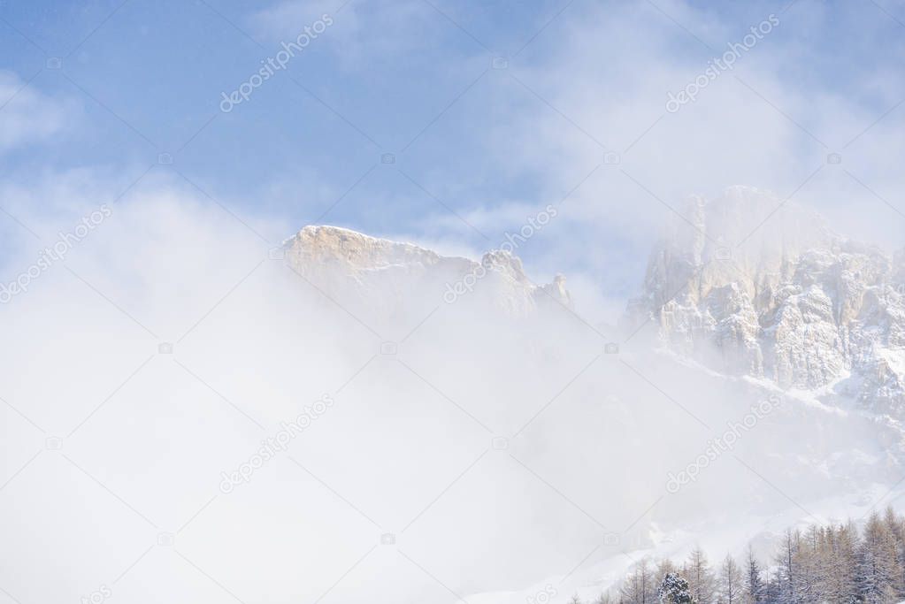 Winter in Dolomites Mountains, Italian Alps, rocky mountains in clouds 