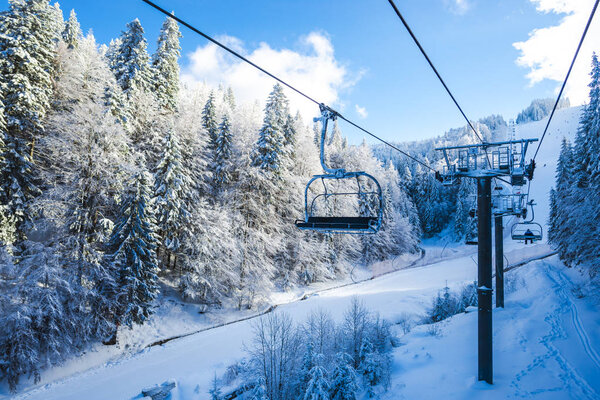 snow covered ski resort in winter mountains and Ski Lift