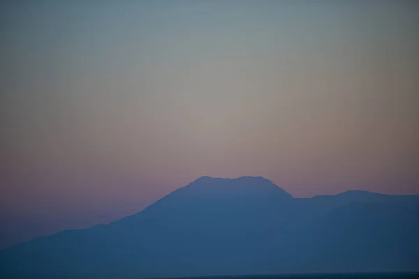 Evening seascape with blurred mountains on background