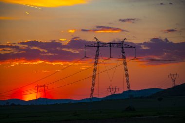 Elektrik direkleri ile gün batımında alan