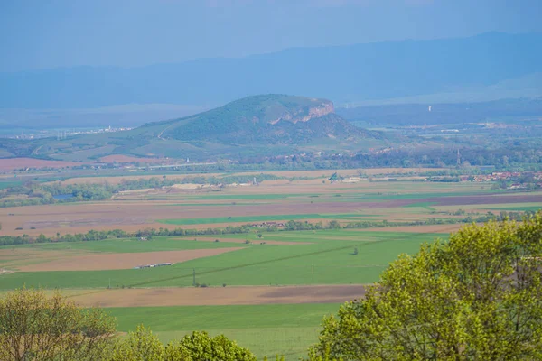 aerial view of city and green hills