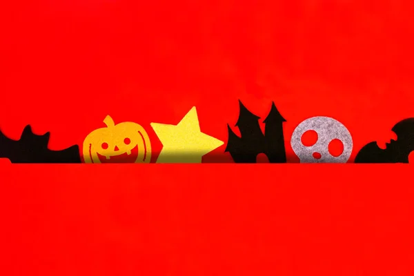 Halloween holiday decorations on red background, Flat lay of Halloween decorations on red,