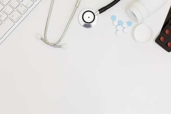 Stethoscope, Top view of doctor's desk table, blank paper on white background, — Stock Photo, Image