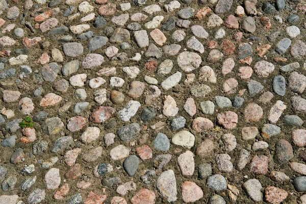 Ancient road surface paved with cobblestone, texture for design and background. — Stock Photo, Image