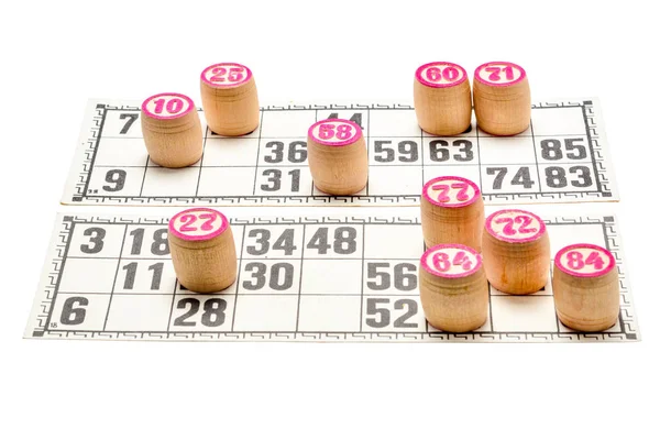 Board game lotto or bingo. Wooden lotto barrels with numbers and card on white table during a game. Vintage game, isolated on white background, Russia.
