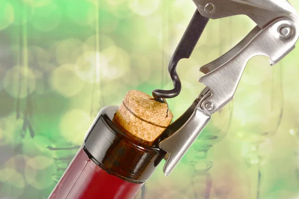 Professional sommelier or waiter knife, pulls out a cork from the bottle of red wine. Corkscrew and bottle opener close up macro. — Stock Photo, Image