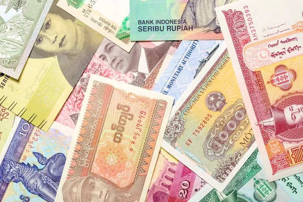 Old paper banknotes from various exotic countries. Colorful money background. Close up. — Stok Foto