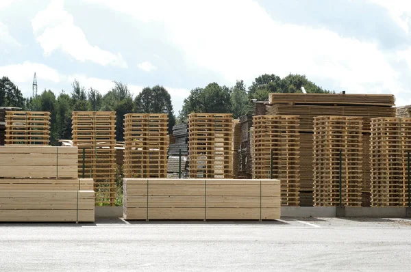 Lumber industry - finished lumber against sky. Machined wood plates deposited and stacked on heaps