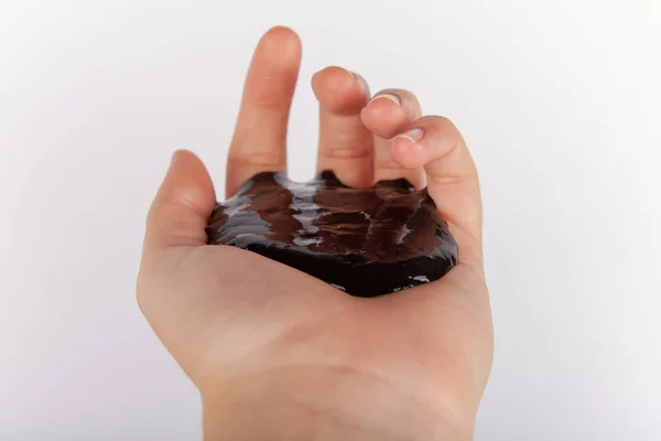 Child Hand Holding Black Slime — Stock Photo, Image