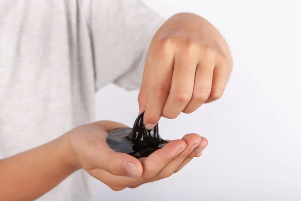 Young Boy Playing Wiht Black Slime His Hand — Stock Photo, Image