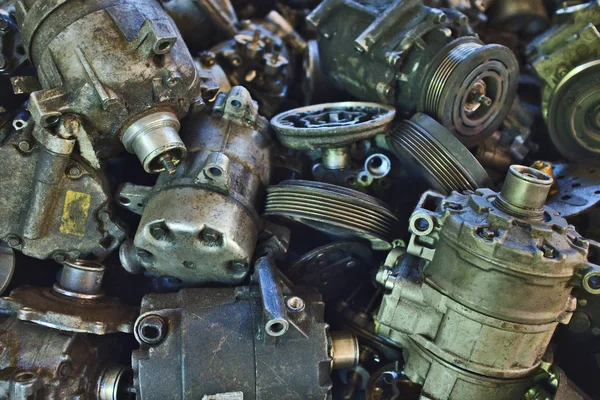 Industrial background with Lots of used car parts like compressors, generators and small engines.