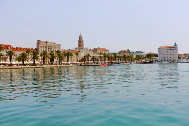 Waterfront of Split old city with the Diocletian Palace and the promenade with palm trees clipart