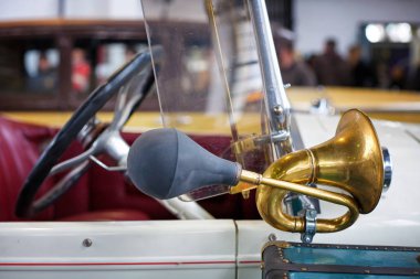 Brass car horn on a vintage car clipart